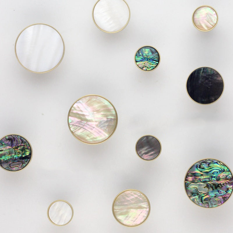 stone and brass cabinet door handles and wall hooks