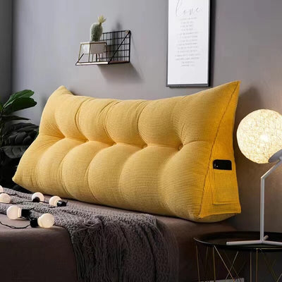 big thick headboard pillow in yellow color with phone pocket on side