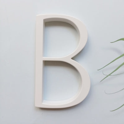 white house numbers, white street address sign, modern white slim house numbers, letter B white